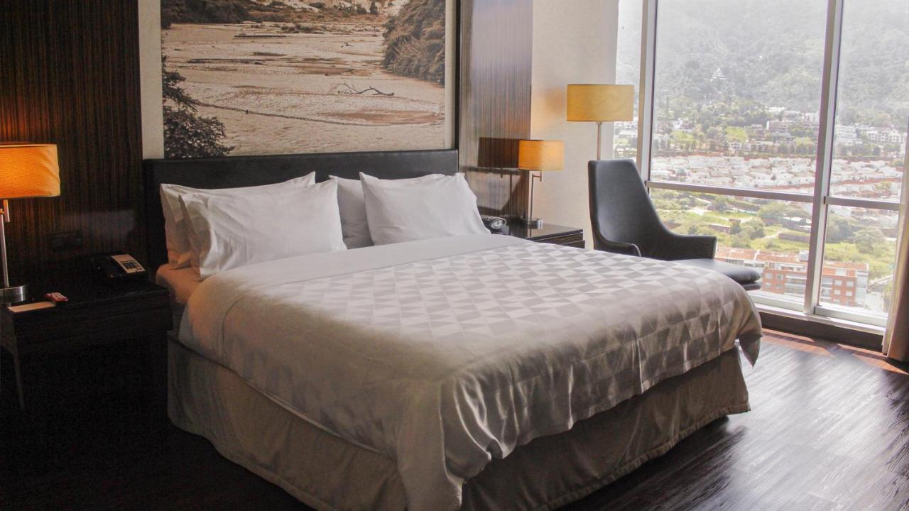 Holiday Inn Bucaramanga Cacique By Ihg Exterior photo A bed with a duvet
